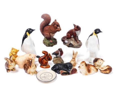 A pair of Poole pottery figures of penguins, together with further glazed and matte figures of animals and birds, and a Purbe