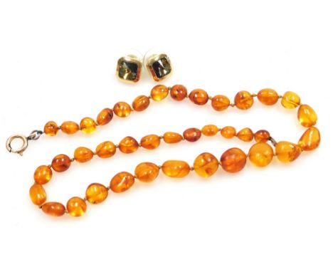 An amber bead necklace, on a bolt ring clasp, 11.6g, together with a pair of Christian Dior costume earrings.