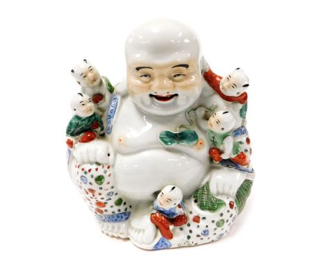 A Chinese porcelain figure of a seated Buddha, with five children, bears oval seal mark, 24cm high.