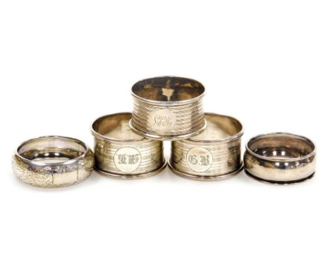 Three George V silver napkin rings, with engine turned decoration, Birmingham 1923, and two further napkin rings, hallmarks w