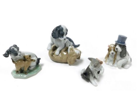 A Lladro Porcelain figure of a kitten, and three Nao Porcelain figures of bride and groom dogs, two puppies playing, and a pu