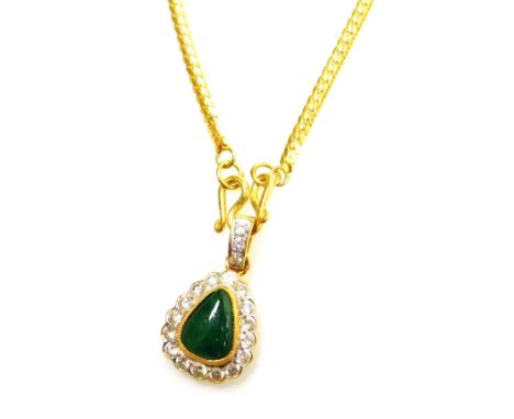 A tear drop jade and diamond set pendant on chain, the central cabachon stone of 8.8mm x 6.8mm widest point, surrounded by ti