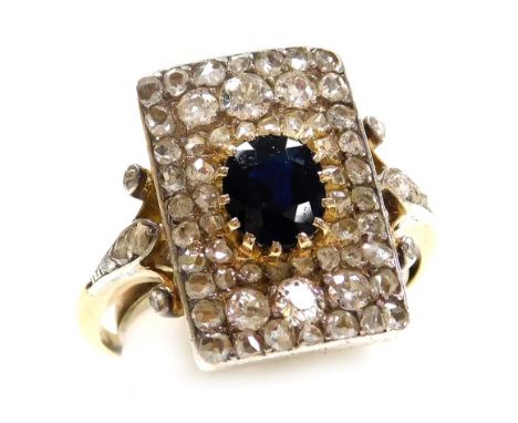 An Art Deco sapphire and diamond ring, set with an oval cut sapphire, rose and old cut diamonds in a yellow and white metal s