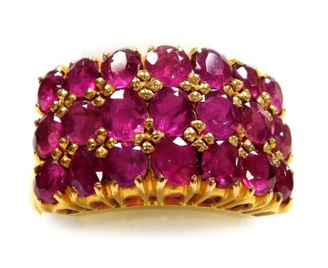 A multi row ruby set dress ring, three rows of seven round faceted stones of 1.6mm diameter average, claw set in precious yel