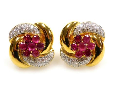 A pair of ruby and diamond set large stud earrings, flower and ribbon form, butterfly backs, the central floral motif of seve