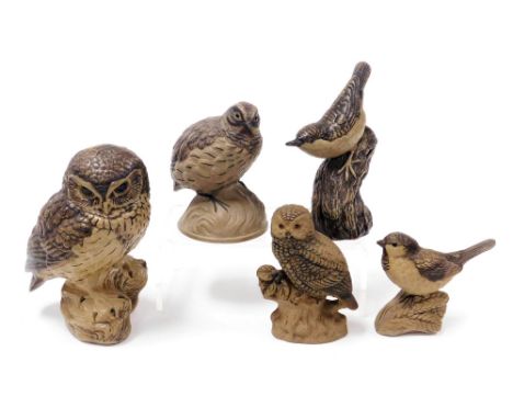 Five Poole buff pottery figures of birds, including a quail, owls, and a wren. 
