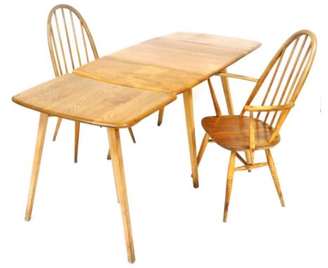 An Ercol light elm drop leaf and extending dining table, in two sections, the drop leaf table raised on tapering outswept sup