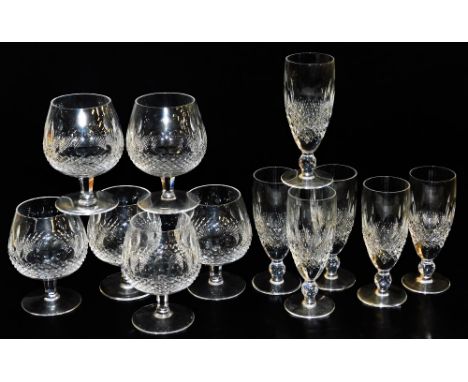 A set of six Waterford Colleen pattern cut glass champagne flutes, together with six brandy balloons.