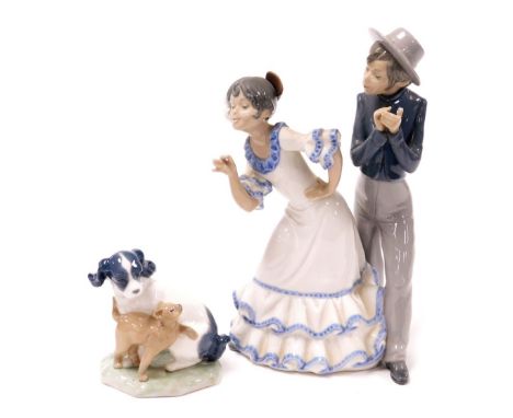 A Nao porcelain figure of young Flamenco dancers, 27.5cm high, together with a Nao figure group of a puppy and a cat. (2)