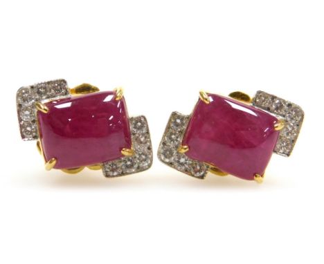 A pair of cushion cabachon ruby and diamond earrings, the central rectangular ruby of 8.7mm x 7mm edged by two diamond set co