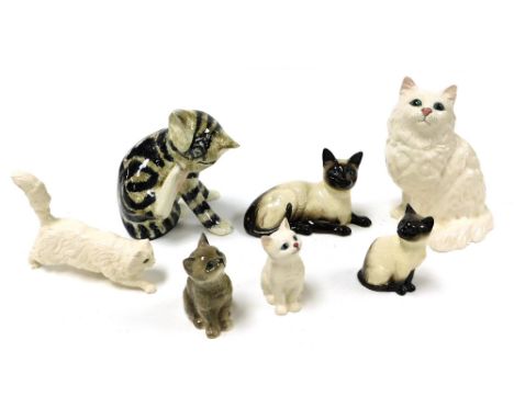 A group of pottery figures of cats, including Beswick, Kensington, and Royal Doulton. (7)