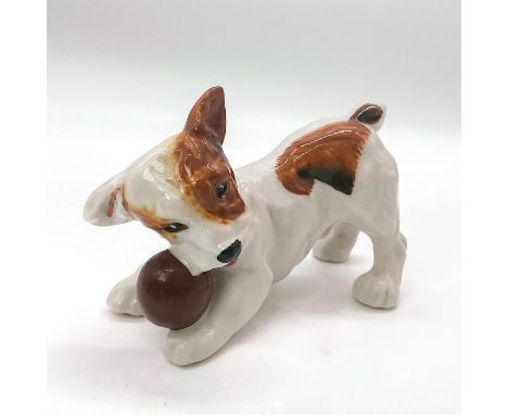 Glaze finish hand painted porcelain depicting an adorable white puppy with light and dark brown patches playing with a brown 