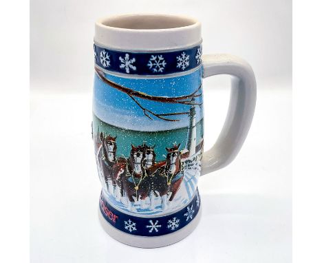 Handcrafted ceramic beer stein featuring The World Famous Budweiser Clydesdales with Hitch and featuring a winter lighthouse 