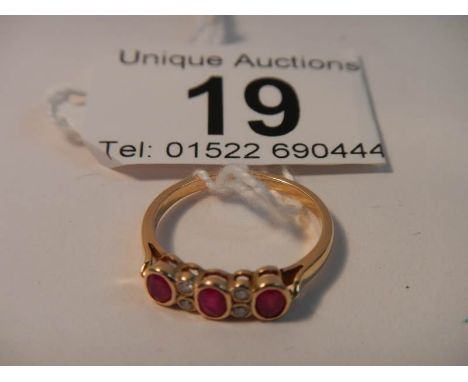 An 18ct gold diamond and ruby ring, Size M (box not included)