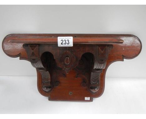 A Victorian mahogany clock bracket, 23" wide x 11.5" high.