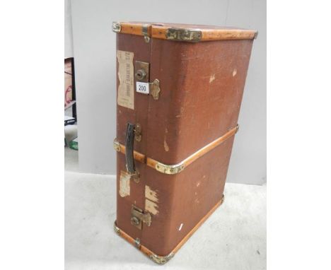 A wooden bound travel trunk in good condition
