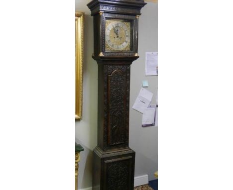 A heavily carved 8 day brass faced Grandfather clock by Geo. Raphams, Brigg.