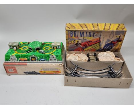 Vintage Tinplate:&nbsp;a 'Made In USSR' clockwork motorway bus station, with key; together with a Brimtoy train set, both box