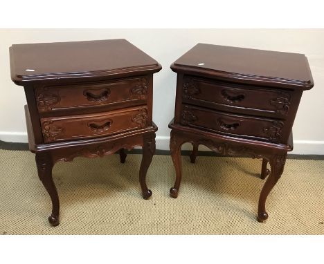 Two pairs of modern Chinese hardwood two drawer bedside chests of serpentine form, raised on cabriole legs to scroll feet, 50