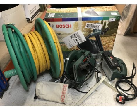 A Bosch universal garden tidy/leaf blower, a Bosch PHO100 electric planer and a Bosch PK46 circular saw and garden hose and r