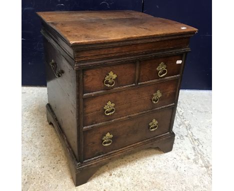 A 19th Century oak portable commode in the 17th Century style, the rising lid opening to reveal a recess over two short and t