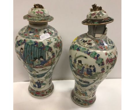 A pair of 19th Century Chinese famille rose polychrome decorated baluster shaped vases with panels of figures, bats, kylin an