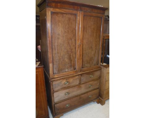 A 19th Century mahogany linen press, the upper section with two panelled doors enclosing a hanging space, formerly with linen