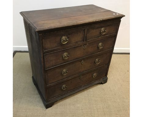 A late 18th Century North Country oak and cross-banded chest, the top with moulded edge over two short and three long graduat