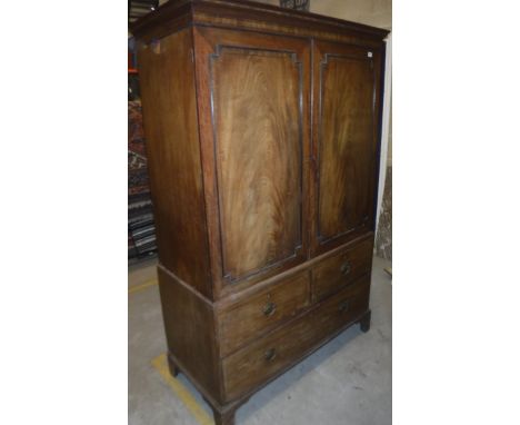 A 19th Century mahogany and rosewood strung linen press, the upper section with moulded cornice above two panelled cupboard d