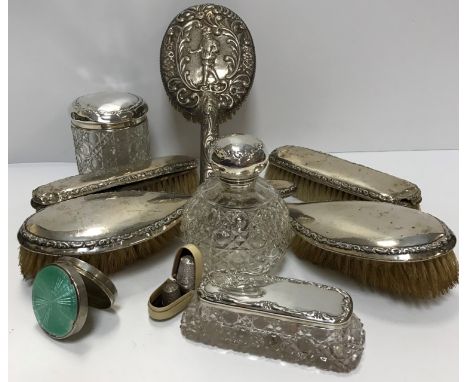 A collection of silver mounted dressing table accountrements to include a grenade scent bottle, hairclip canister, etc and si