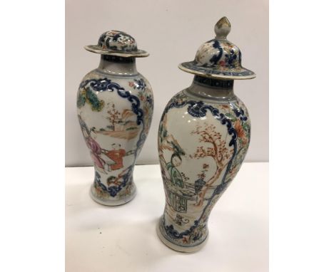 A pair of 19th Century Chinese blue and white and polychrome decorated baluster shaped vases and covers, the main bodies deco