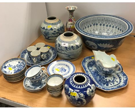 A collection of Chinese pottery and porcelain to include a blue and white sauceboat decorated with dwellings by water side (s