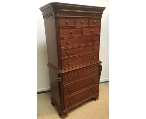 A modern mahogany chest on chest in the Georgian style, the moulded cornice above a blind fretwork frieze and five small draw