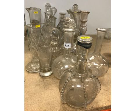 A collection of thirteen various cut glass or blown glass decanters and ewers, various sizes and vintages, three cut glass ju