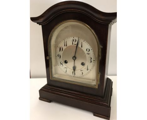 An early 20th Century mahogany cased mantel clock, the eight day movement with silvered arched dial and Arabic numerals by Ju