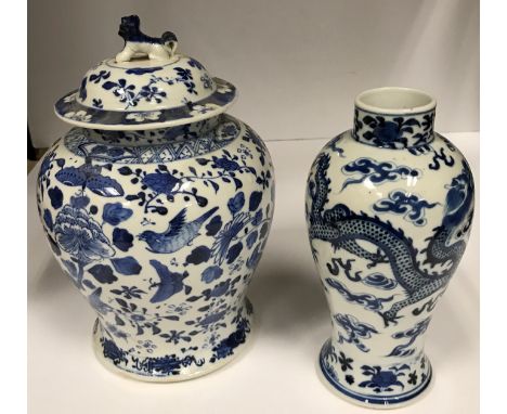 A circa 1900 Chinese blue and white baluster shaped vase decorated with four toed dragons chasing a flaming pearl amongst clo