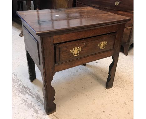 An oak side table in the 17th Century style, the plank top over a single frieze drawer on fretwork carved bracket supports, 8