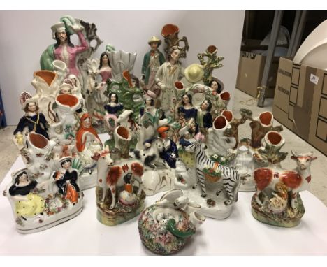 A collection of sixteen various Staffordshire spill vases to include a pair of figures by road sign "London 30 miles" 16.8 cm