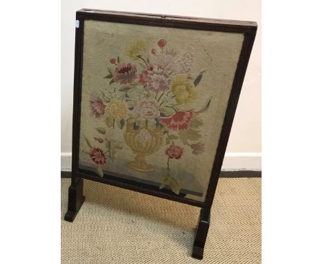 A 19th Century Scottish mahogany framed fire screen with adjustable side panels and top panel, the centre panel with embossed