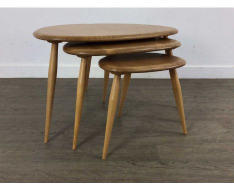 ERCOL, NEST OF THREE MODEL 354 'PEBBLE' ELM TABLES, CIRCA 1960-69 the 'oyster' tops on splayed beech supportlargest 40cm high