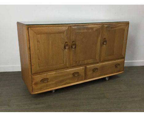 ERCOL, WINDSOR MODEL 468 BLONDE ELM SIDEBOARD, with three cupboard doors over two short drawers, on castors77cm, 129cm wide, 