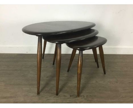 ERCOL, NEST OF MODEL 354 STAINED ELM 'PEBBLE' TABLES, the 'oyster' tops on splayed beech supportsNo cracks but the larger two