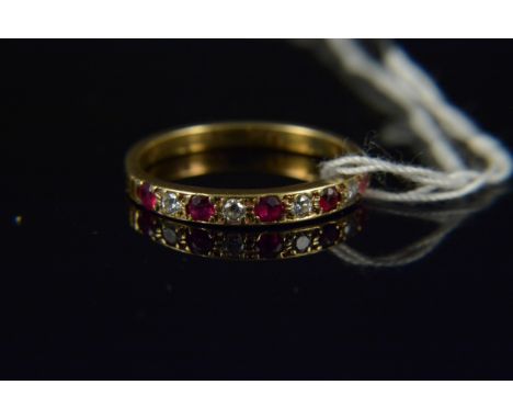 A ruby and diamond half eternity style ring, the alternating ruby and diamond stones in four claw setting, size O 1/2, weight