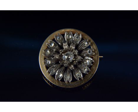 An antique yellow and white metal diamond brooch, the circular yellow metal framing large white metal old cut diamond set flo