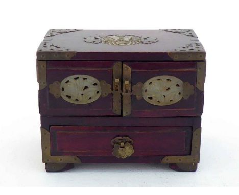 A Chinese brass-mounted wooden jewellery cabinet, inlaid with jade plaques on the top and front, silk-lined inside. 20th cent