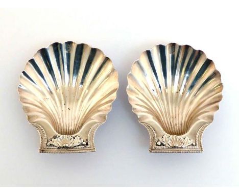 A pair of George III silver butter shells possibly by Thomas Pitts (II), London, 1808, on three mollusc feet, the ends with d