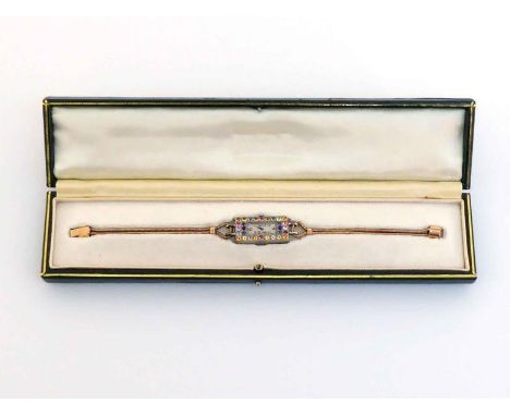An Art Deco platinum and multigem cocktail watch, the rectangular case set with sapphire, ruby, and topaz, the silvered dial 