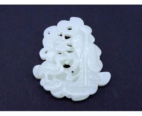 A Chinese carved white jade plaque, finely pierced in the form of ‘Shou’ character on one side, the other side carved as a sa