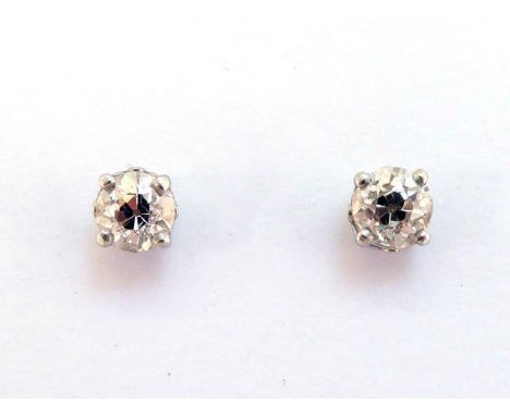 A pair of single stone diamond ear studs, each old brilliant cut stone approx. 0.57 carat, platinum mounted, post and butterf