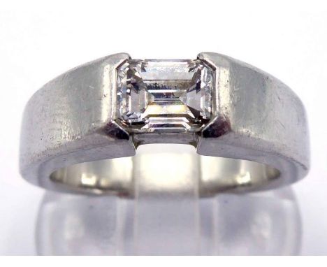 A platinum and diamond single stone ring, the emerald cut approx. 0.95 carat, rub over set, fully hallmarked, finger size N, 